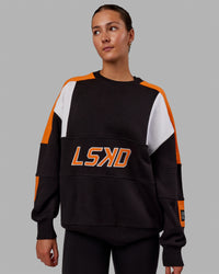 Woman wearing Unisex Slam Sweater Oversize - Black-Ultra Orange | Thumbnail Index: 1