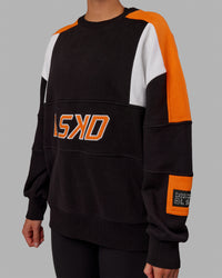 Woman wearing Unisex Slam Sweater Oversize - Black-Ultra Orange | Thumbnail Index: 6
