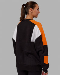 Woman wearing Unisex Slam Sweater Oversize - Black-Ultra Orange | Thumbnail Index: 10