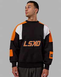 Man wearing Unisex Slam Sweater Oversize - Black-Ultra Orange | Thumbnail Index: 5