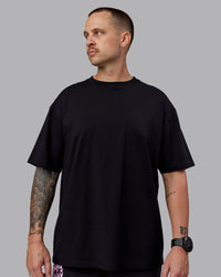 Man wearing Unisex So Cal 24 FLXCotton Tee Oversize - Black-Beacon Orange | Thumbnail Index: 2