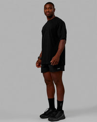 Man wearing Unisex Stamped 2.0 Heavyweight Tee Oversize - Black | Thumbnail Index: 6