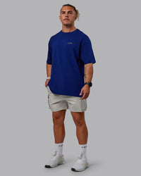 Man wearing Unisex Strike Through FLXCotton Tee Oversize - Midnight Blue-Vibrant Orange | Thumbnail Index: 3