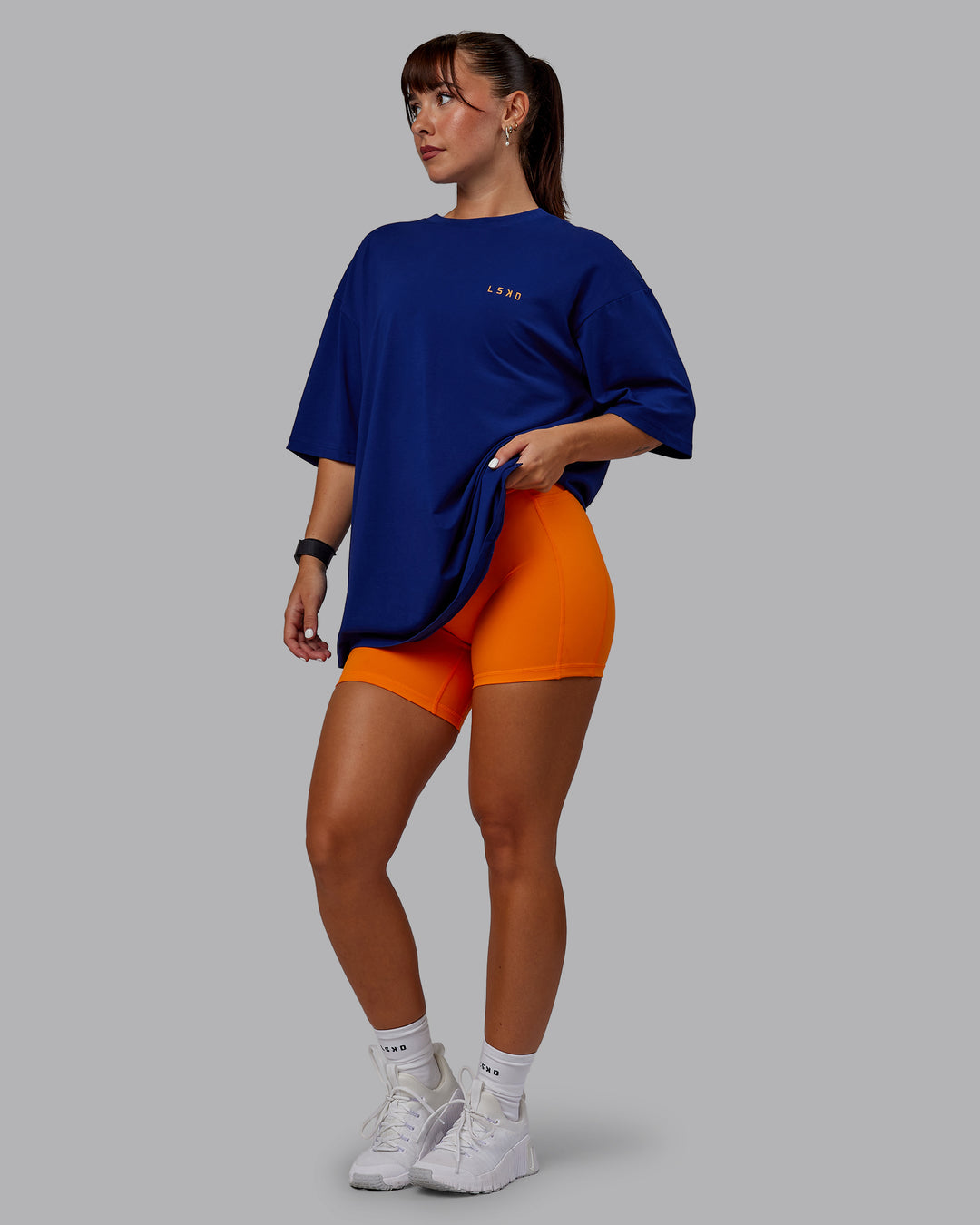 Woman wearing Unisex Strike Through FLXCotton Tee Oversize - Midnight Blue-Vibrant Orange - view 5