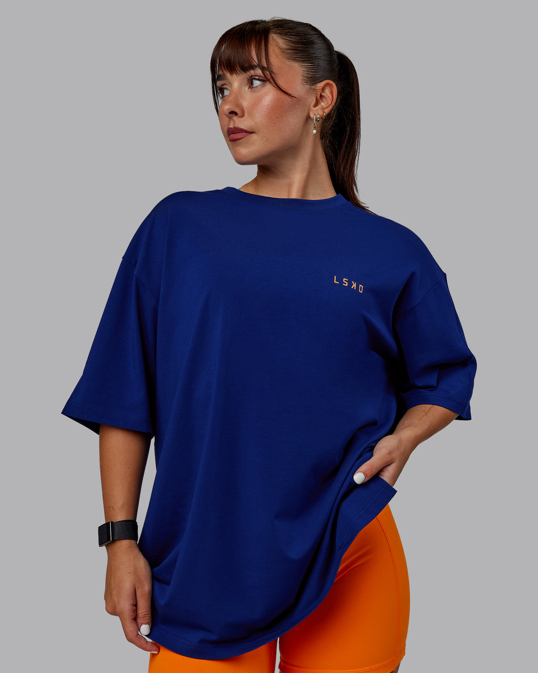 Woman wearing Unisex Strike Through FLXCotton Tee Oversize - Midnight Blue-Vibrant Orange - view 3