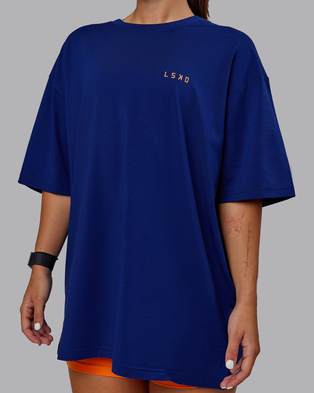 Woman wearing Unisex Strike Through FLXCotton Tee Oversize - Midnight Blue-Vibrant Orange - view 8