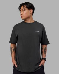 Man wearing Unisex Strike Through FLXCotton Tee Oversize - Pirate Black-Black | Thumbnail Index: 3