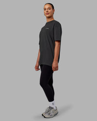 Woman wearing Unisex Strike Through FLXCotton Tee Oversize - Pirate Black-Black | Thumbnail Index: 6