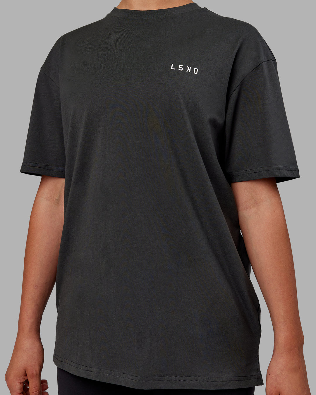 Woman wearing Unisex Strike Through FLXCotton Tee Oversize - Pirate Black-Black - view 9