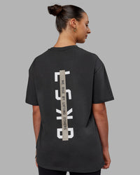 Woman wearing Unisex Strike Through FLXCotton Tee Oversize - Pirate Black-Black | Thumbnail Index: 4