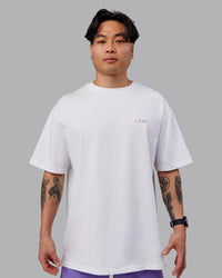 Man wearing Unisex Strike Through FLXCotton Tee Oversize - White-Purple Swirl | Thumbnail Index: 3