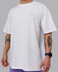 Man wearing Unisex Strike Through FLXCotton Tee Oversize - White-Purple Swirl | Thumbnail Index: 9