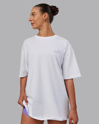 Woman wearing Unisex Strike Through FLXCotton Tee Oversize - White-Purple Swirl | Thumbnail Index: 2