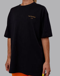 Woman wearing Unisex Trust The Process 2.0 FLXCotton Tee Oversize - Black-Vibrant Orange | Thumbnail Index: 8