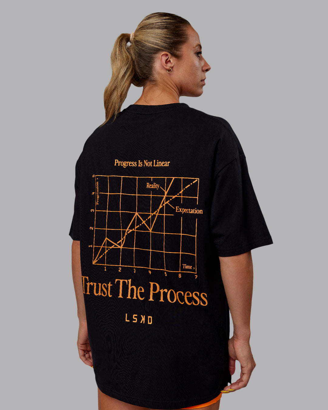 Woman wearing Unisex Trust The Process 2.0 FLXCotton Tee Oversize - Black-Vibrant Orange - view 2