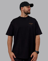 Man wearing Unisex Trust The Process 2.0 FLXCotton Tee Oversize - Black-Vibrant Orange | Thumbnail Index: 2