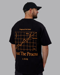 Man wearing Unisex Trust The Process 2.0 FLXCotton Tee Oversize - Black-Vibrant Orange | Thumbnail Index: 7