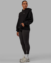 Woman wearing Unisex VS6 Hoodie Oversize - Black-White | Thumbnail Index: 3