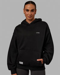 Woman wearing Unisex VS6 Hoodie Oversize - Black-White | Thumbnail Index: 5