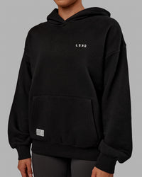 Woman wearing Unisex VS6 Hoodie Oversize - Black-White | Thumbnail Index: 10