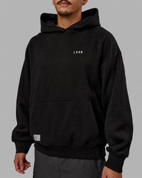 Man wearing Unisex VS6 Hoodie Oversize - Black-White | Thumbnail Index: 7