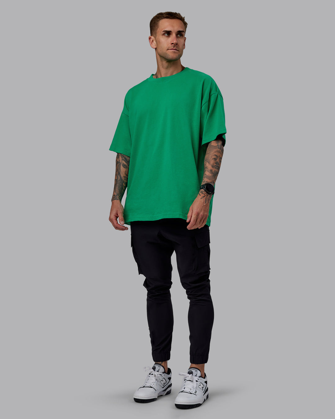 Man wearing Unisex We Rise Heavyweight Tee Oversize - Impact Green-White - view 7