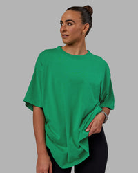 Woman wearing Unisex We Rise Heavyweight Tee Oversize - Impact Green-White | Thumbnail Index: 5