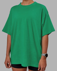 Woman wearing Unisex We Rise Heavyweight Tee Oversize - Impact Green-White | Thumbnail Index: 7