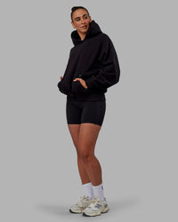 Woman wearing Unisex We Rise Hoodie Oversize - Black-Impact Green | Thumbnail Index: 5