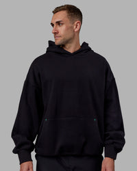 Man wearing Unisex We Rise Hoodie Oversize - Black-Impact Green | Thumbnail Index: 2