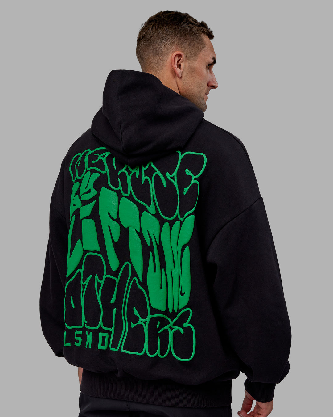 Man wearing Unisex We Rise Hoodie Oversize - Black-Impact Green - view 8