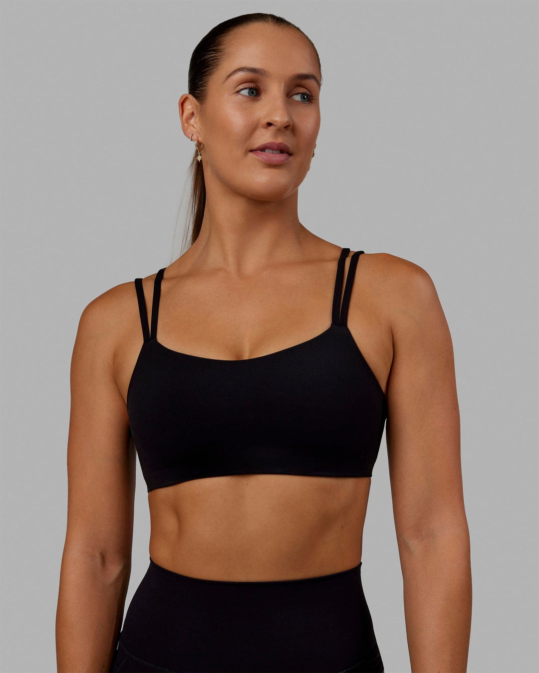 Woman wearing Vantage Sports Bra - Black - view 1