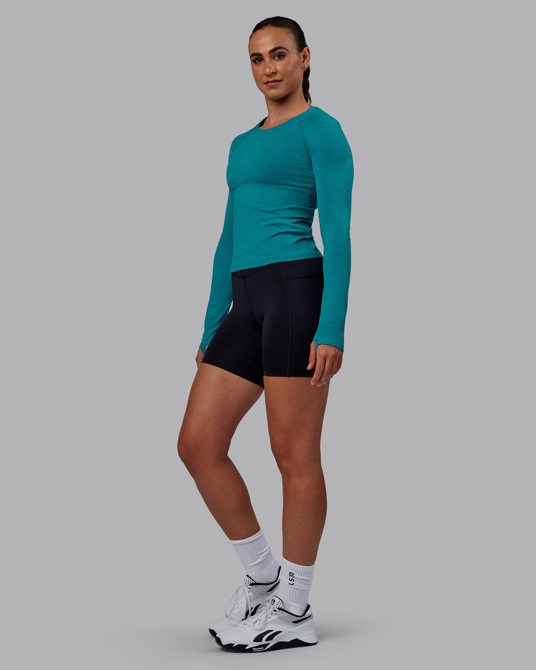 Woman wearing AeroFLX+ Seamless Long Sleeve Tee - Blue Bird Marl - view 4
