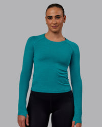 Woman wearing AeroFLX+ Seamless Long Sleeve Tee - Blue Bird Marl | Thumbnail Index: 1
