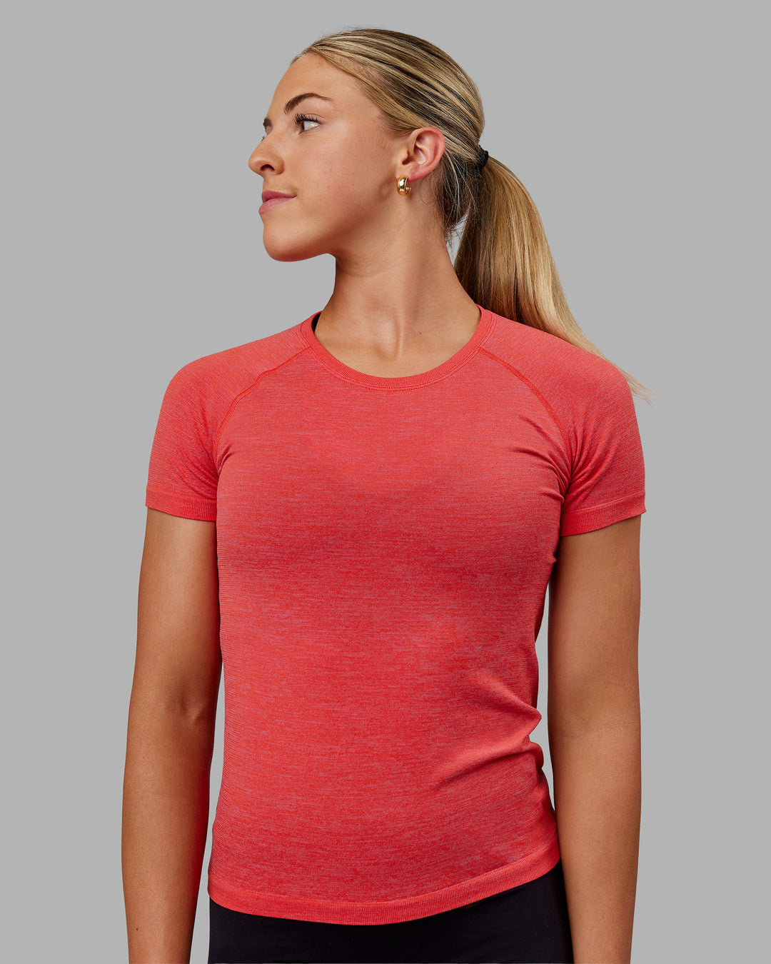 Woman wearing AeroFLX+ Seamless Tee - Fuchsia Pink/Grenadine - view 1