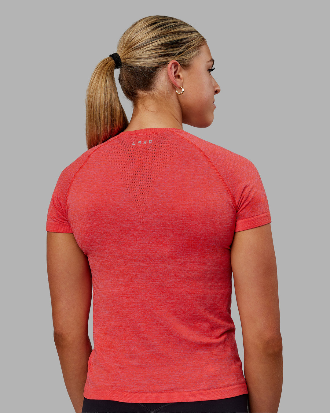 Woman wearing AeroFLX+ Seamless Tee - Fuchsia Pink/Grenadine - view 6