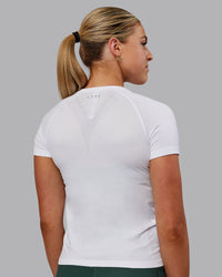 Woman wearing AeroFLX+ Seamless Tee - White/White | Thumbnail Index: 3