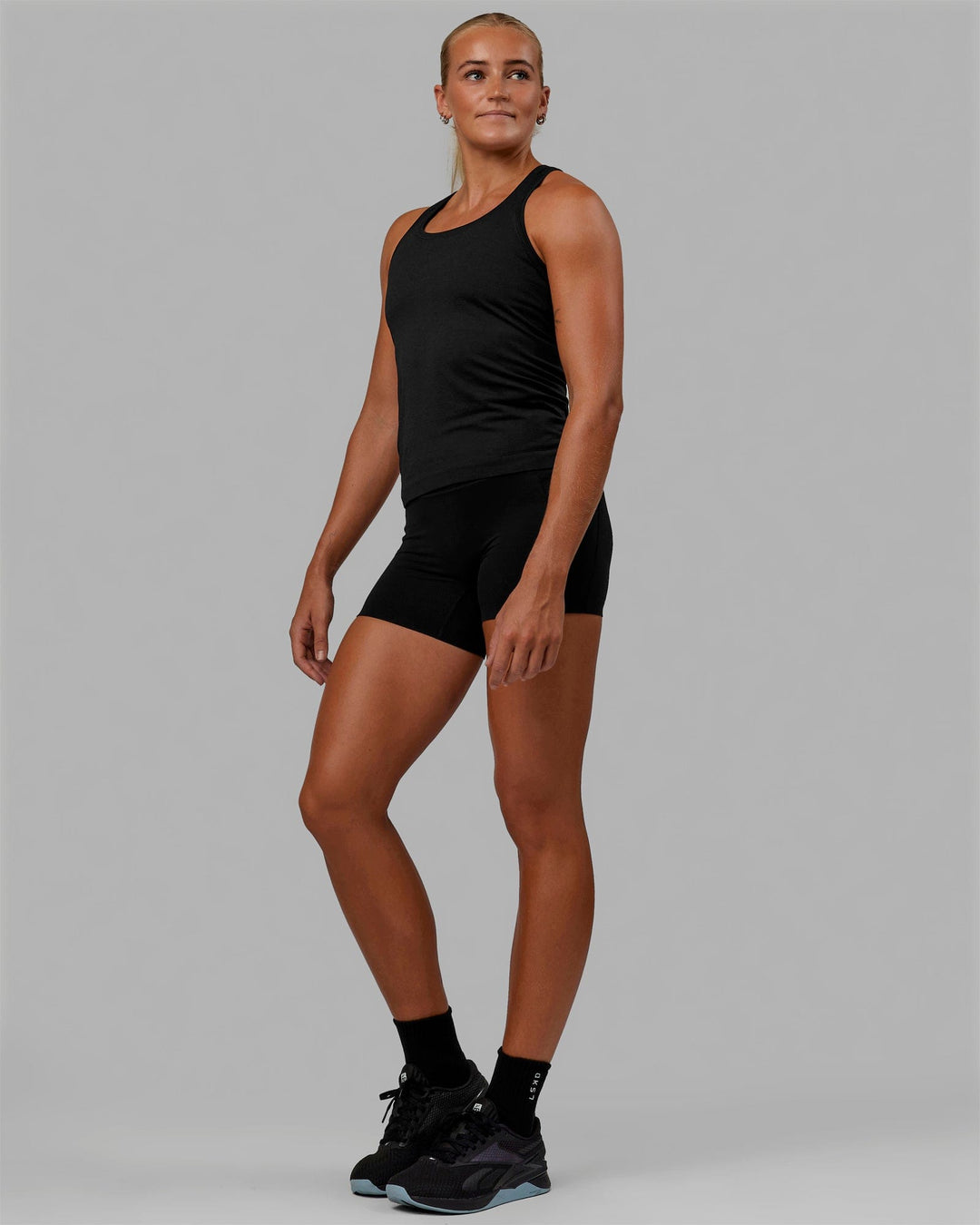 Woman wearing AeroFLX+ Seamless Tank - Black Marl - view 3