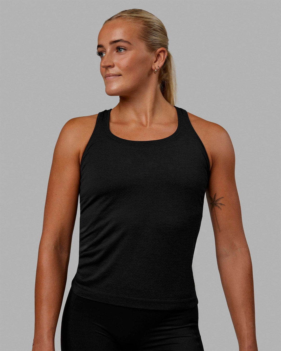 Woman wearing AeroFLX+ Seamless Tank - Black Marl - view 9