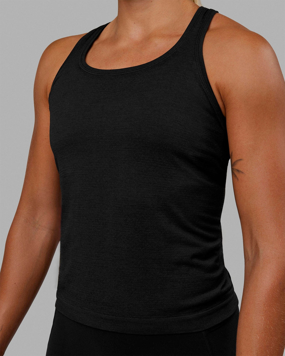 Woman wearing AeroFLX+ Seamless Tank - Black Marl - view 6