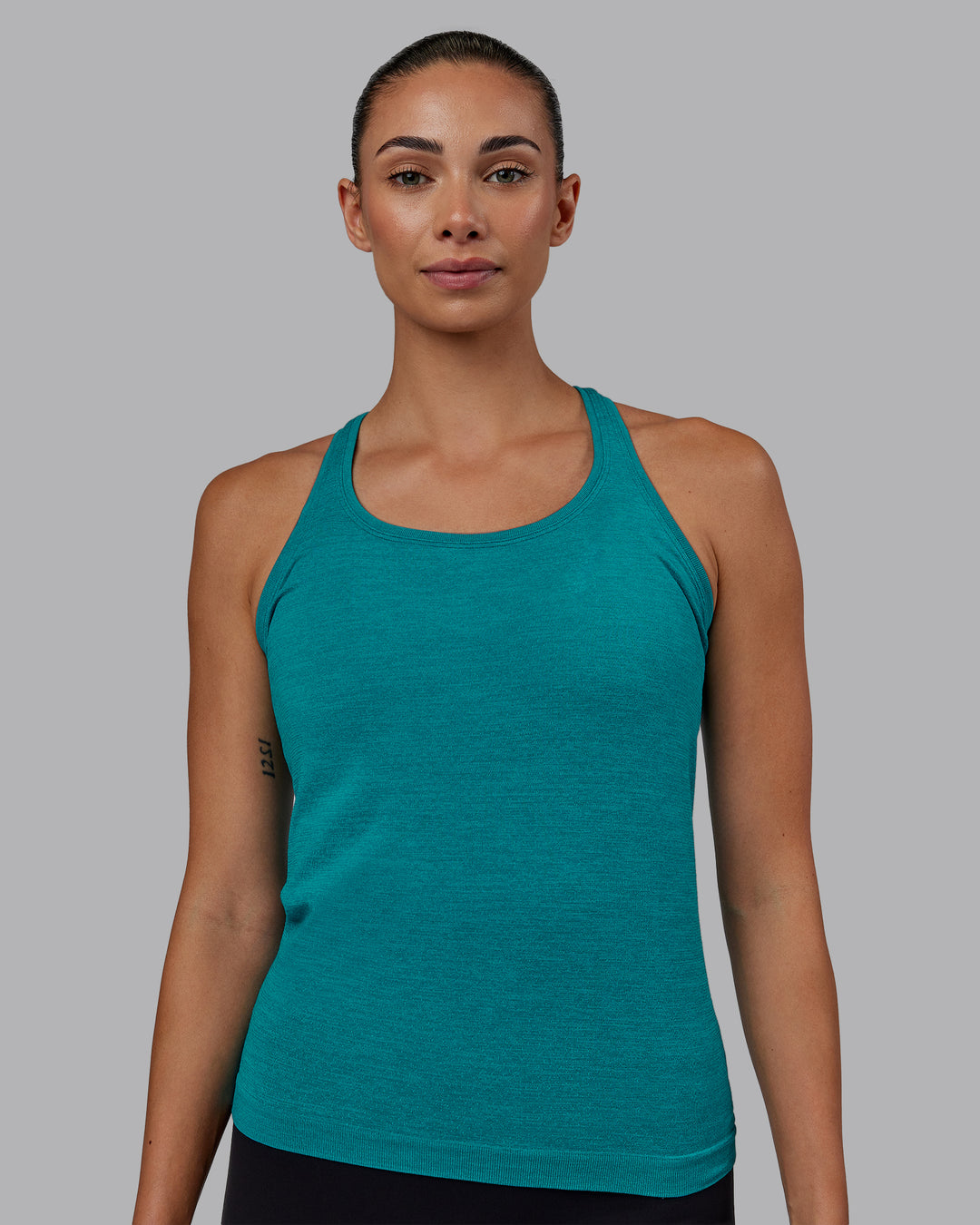 Woman wearing AeroFLX+ Seamless Tank - Blue Bird Marl - view 1