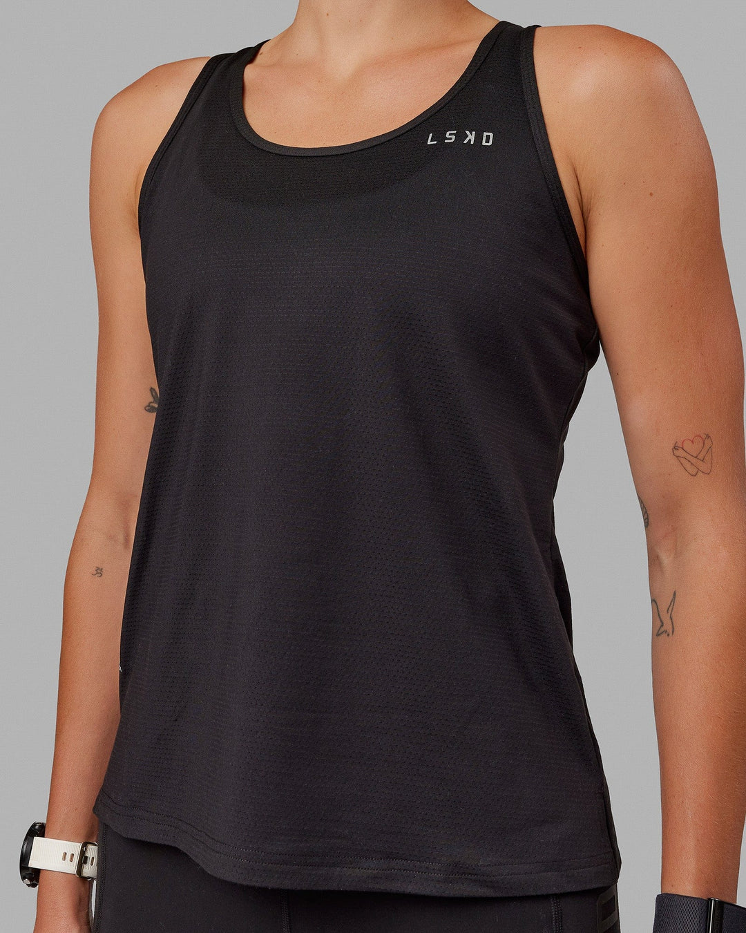 Woman wearing Perform VapourFLX Tank - Black - view 7