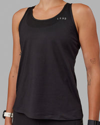 Woman wearing Perform VapourFLX Tank - Black | Thumbnail Index: 6