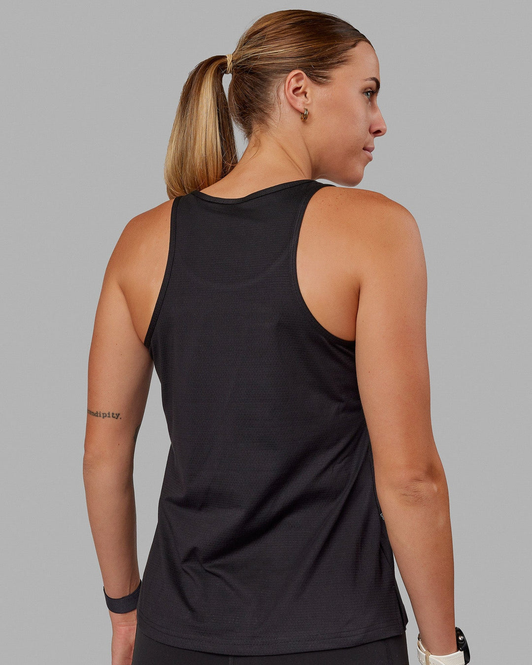 Woman wearing Perform VapourFLX Tank - Black - view 4