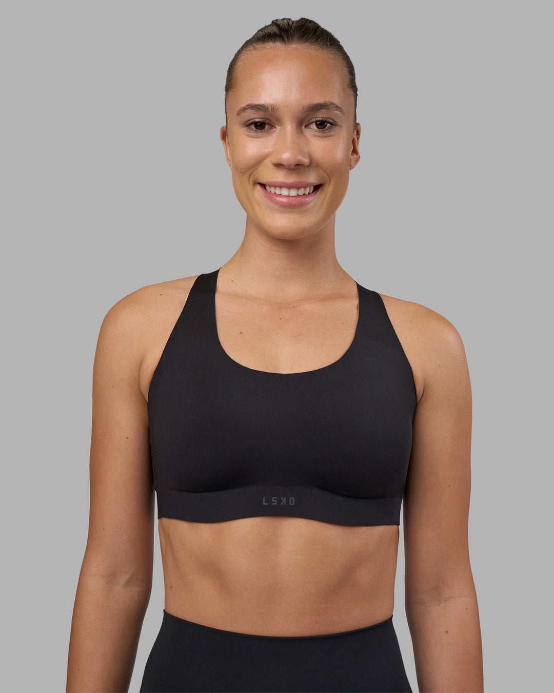 Woman wearing Stability Sports Bra - Black | Model:Charlize | Size:S (A-C Cup) - view 3