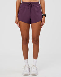 Woman wearing Accelerate 3" High-Rise Running Short - Midnight Plum | Set:true | Angle:front | Model:Rhiley | Size:S | Thumbnail Index: 0