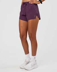 Woman wearing Accelerate 3" High-Rise Running Short - Midnight Plum | Set:true | Angle:side | Model:Rhiley | Size:S | Thumbnail Index: 6