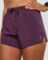 Woman wearing Accelerate 3" High-Rise Running Short - Midnight Plum | Set:true | Angle:closeup | Model:Rhiley | Size:S | Thumbnail Index: 1