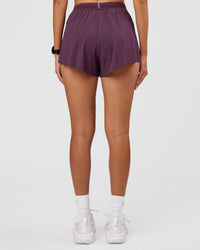 Woman wearing Accelerate 3" High-Rise Running Short - Midnight Plum | Set:true | Angle:back | Model:Rhiley | Size:S | Thumbnail Index: 3