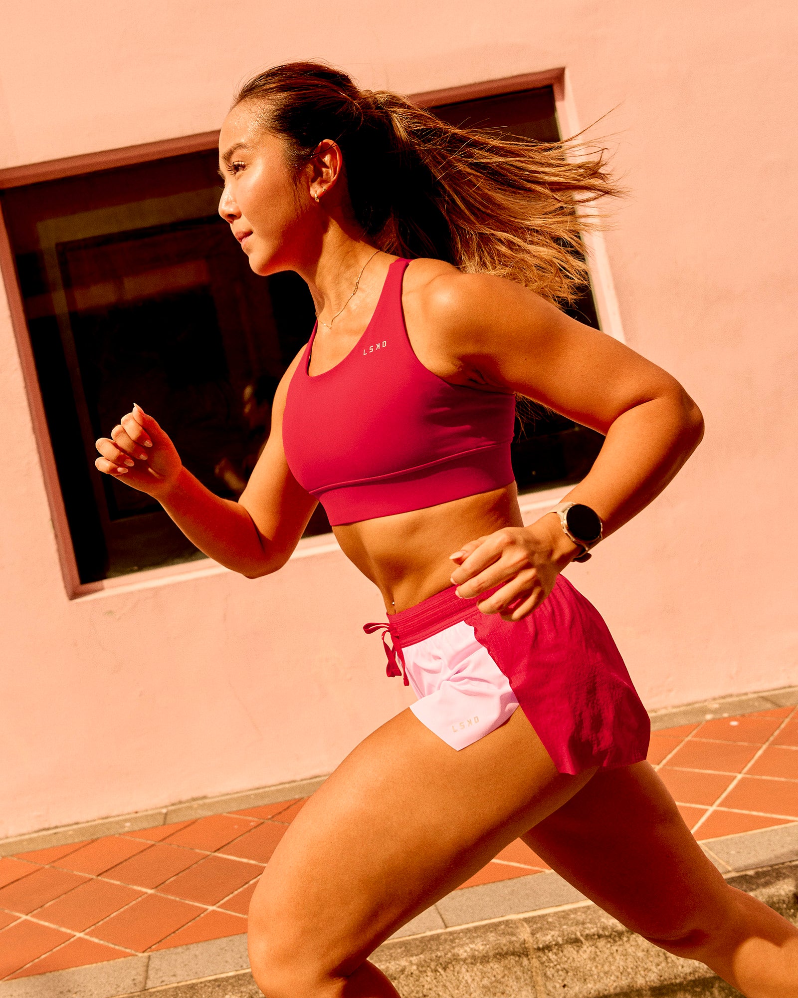 Woman wearing Accelerate 3" Mid-Rise Running Short - Scarlet-Marshmallow | Model:Clare | Size:S